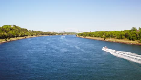 Panning-aerial-view-over-Cape-Cod-Canal,-Sagamore-bridge-in-the-distance