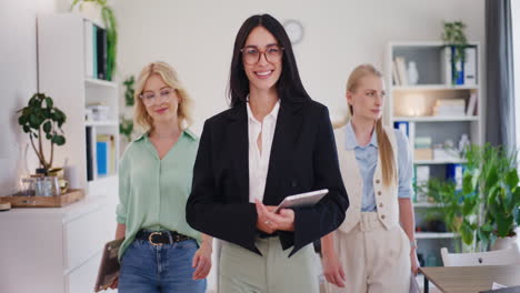 businesswoman and colleagues walking, happy and successful