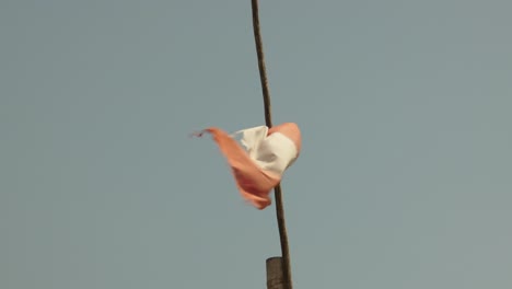 close up of a tattered peruvian flag waving in the wind