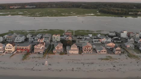 well beach real estate housing stretching along shoreline sunrise aerial