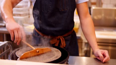 chef preparing crepe on the pan