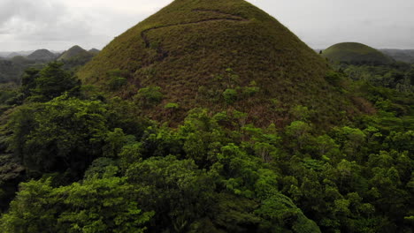 aerial tilt reveal chocolate hills with dramatic sky in bohol, philippines 4k