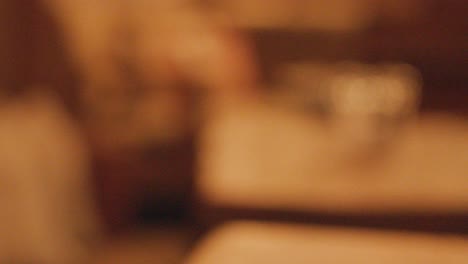 pint of dark stout beer on wooden pub table, warm lighting, shallow focus, cinematic feel