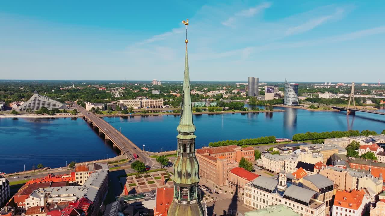Drone slowly moves forward showing St Peters Church spire and Riga skyline