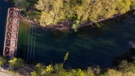 Scenic-high-bird's-eye-view-of-bridge-and-calm-Snoqualmie-Middle-fork-River-in-North-Bend,-Washington-State