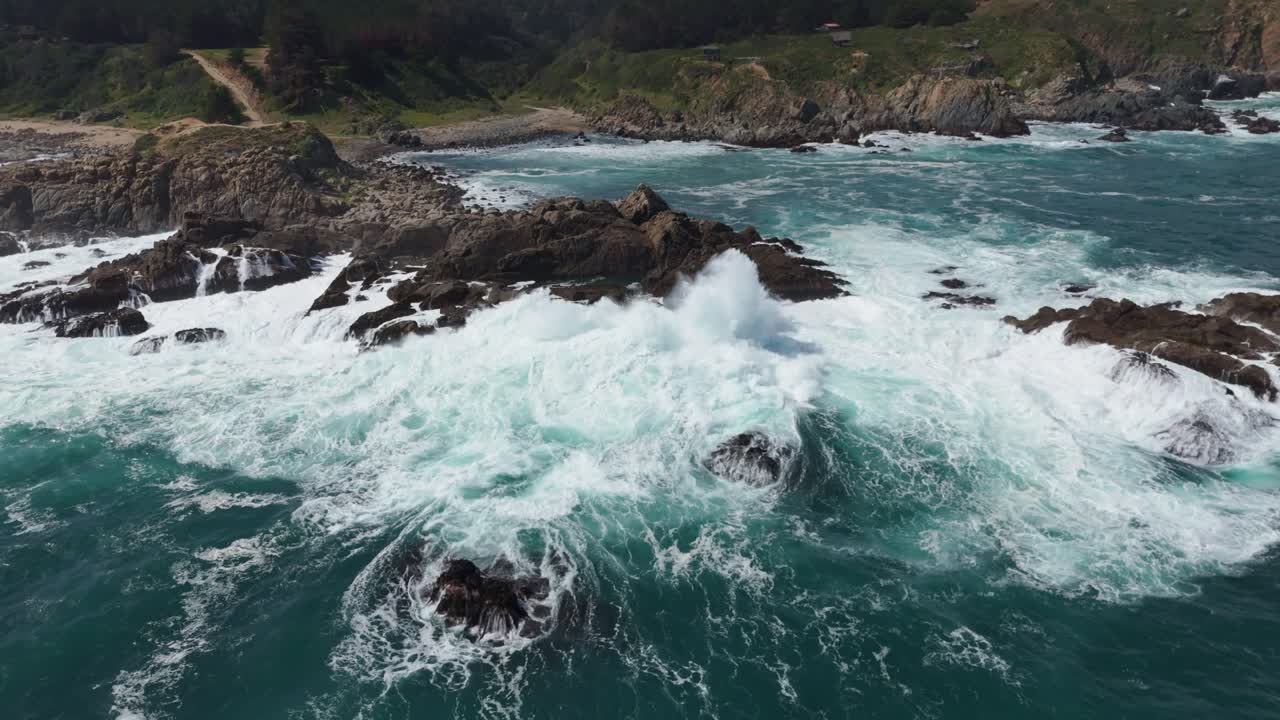 Aerial View Of Powerful waves are crashing against a rocky shore, creating a dramatic scene of nature's power