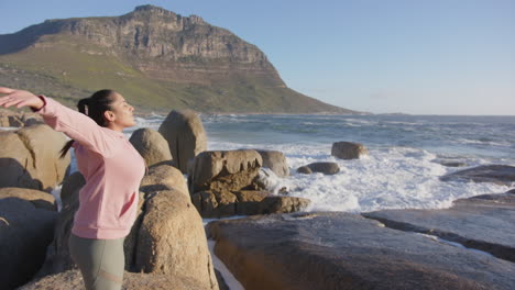 relaxing by ocean, asian woman stretching arms and enjoying nature's beauty, copy space