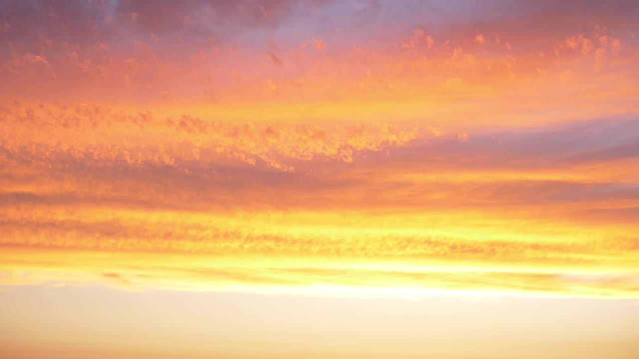 Orange cloudscape at sunset slow panning shot