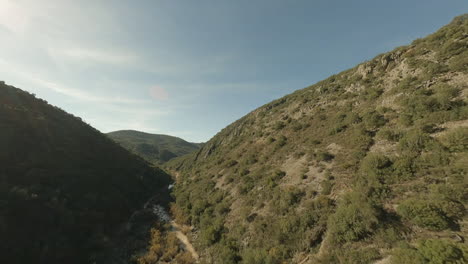 fpv aerial up rugged, rocky, arid river valley near seville, spain