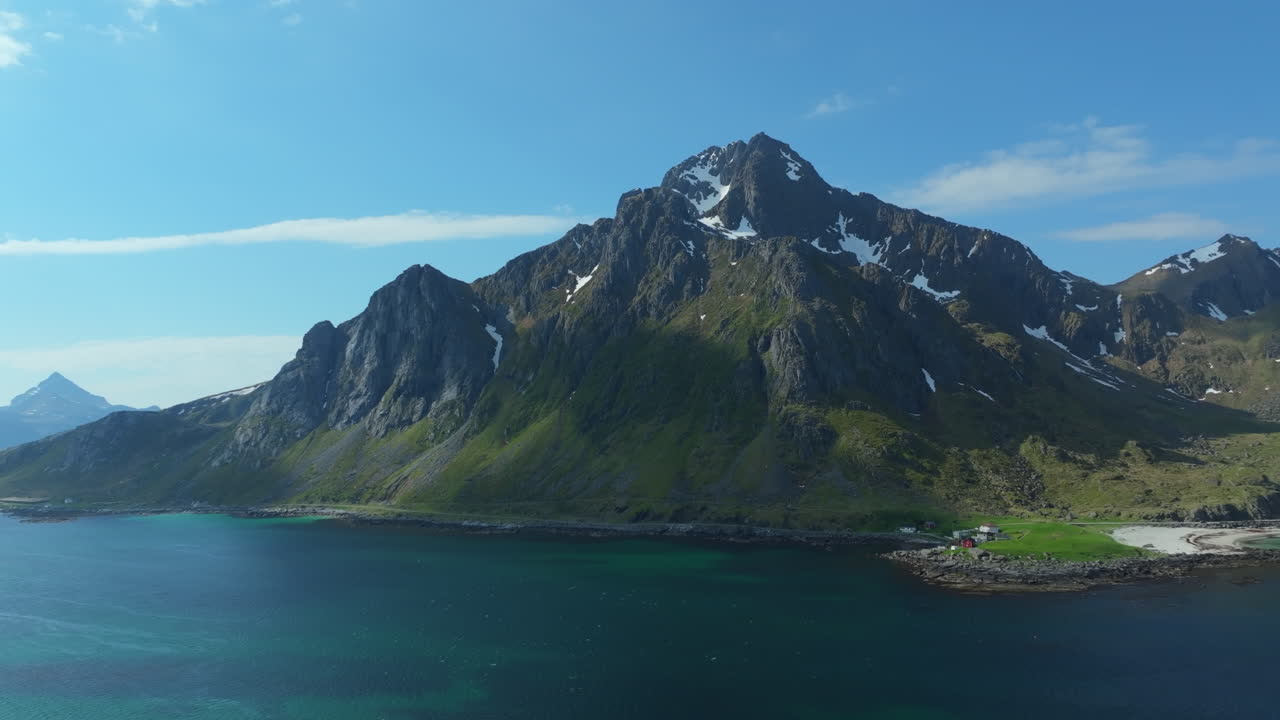Breathtaking aerial perspective of Storsandnes Beach, with a majestic mountain dominating the landscape in Lofoten, Norway