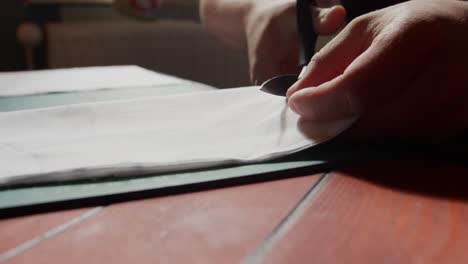 slow motion cutting of fabric on a table