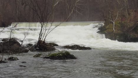 strong rapids on a little waterfall after recent winter snow melt, in beacon ny