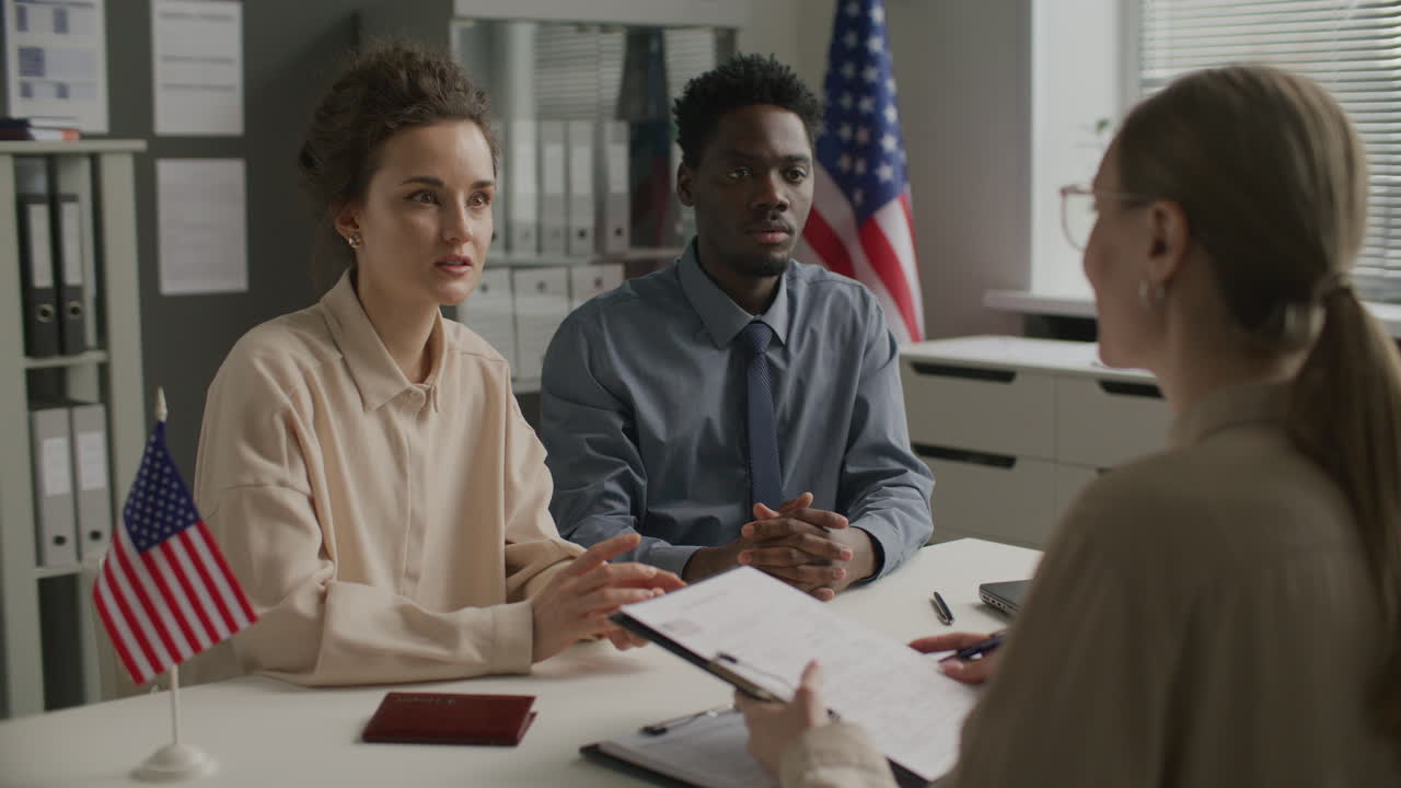 Diverse Couple Having Visa Interview with Consular Officer at US Embassy