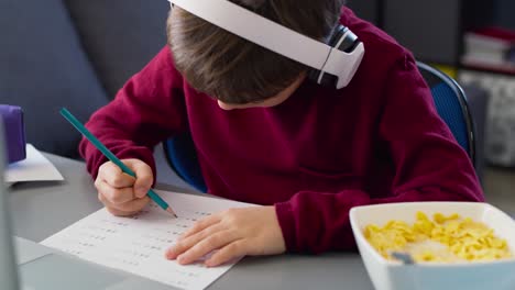 close up of boy during doing math equation at home