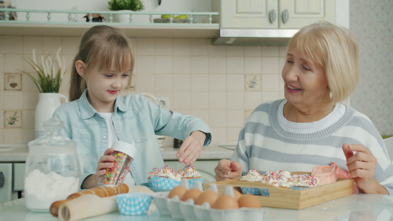 Grandmother and Granddaughter Baking Cupcakes