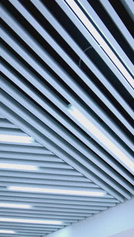 white ceiling with lighting in room. ceiling lights custom designed for an office business building