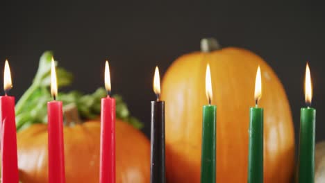 composition of seven lit candles and halloween pumpkins