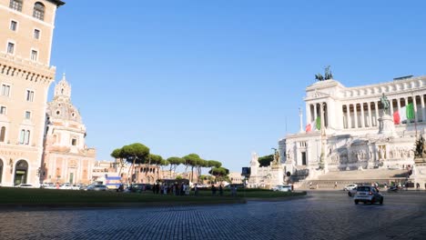 Basilica-Ulpia-and-Victor-Emmanuel-II-National-Monument,-also-known-as-Altare-della-Patria-,-Traffic-in-Rome,-Italy