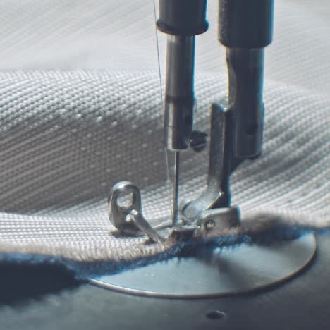 sewing machine foot on material with threaded needle