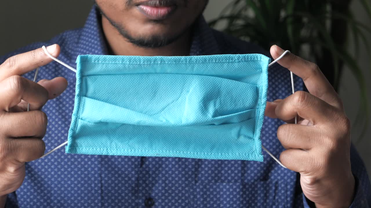 persona con una máscara facial azul