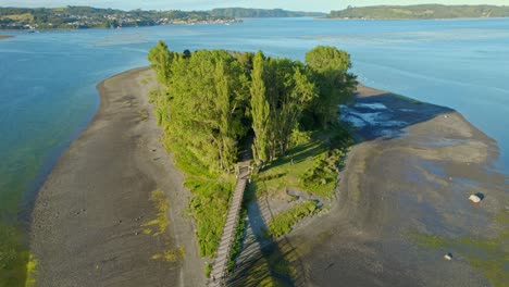 Floating-Cemetery-at-Isla-Aucar-Chiloé,-Patagonian-Island-Lansdcape-Aerial-Drone-View,-Seascape-at-Summer-Daylight,-Green-Islet-around-Black-Sand