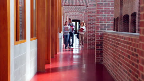 smiling students walking down the hall