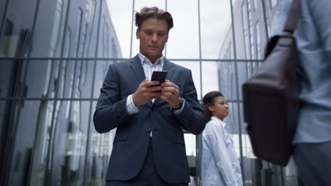 confident businessman get good news on smartphone portrait. victory concept