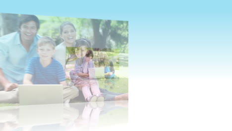 families using laptops in a park