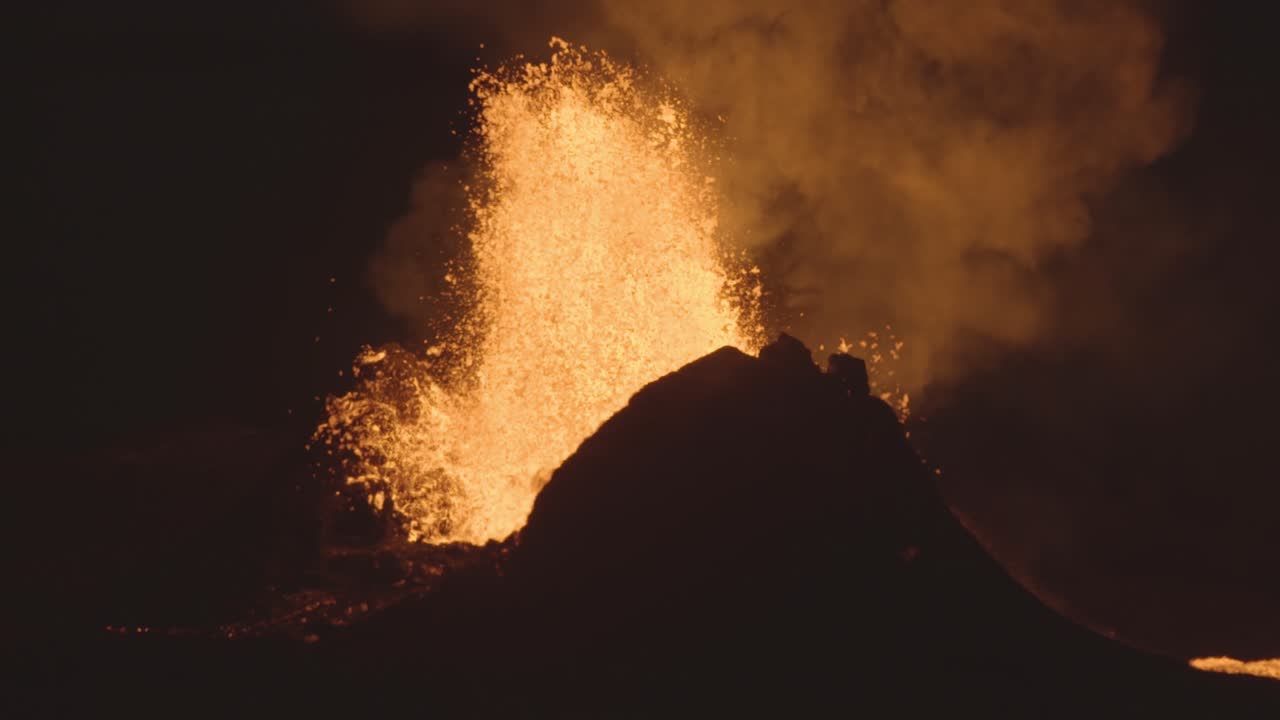 Powerful volcanic fountain eruption at night close up Iceland