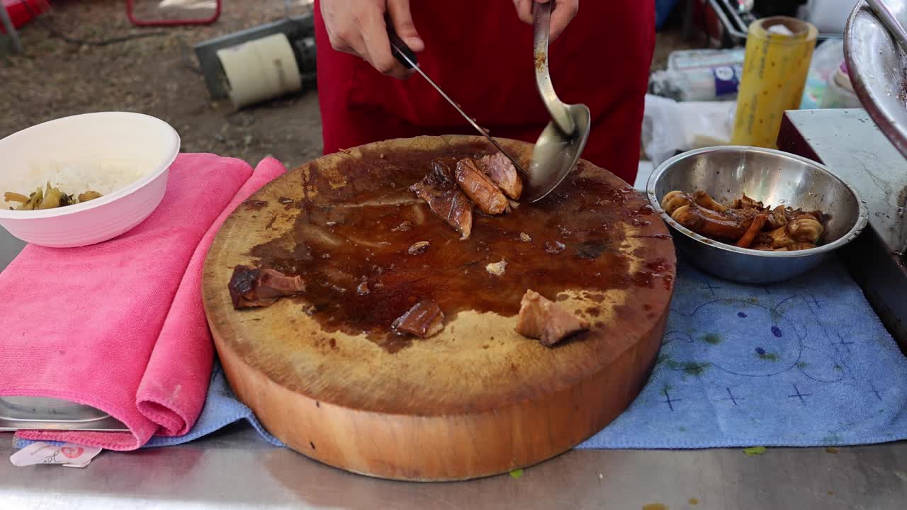 Scooping and serving stew from a large pot.
