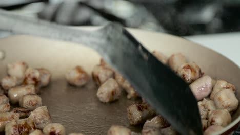 Cooking-chopped-sausages-in-the-morning-for-breakfast-in-slow-motion