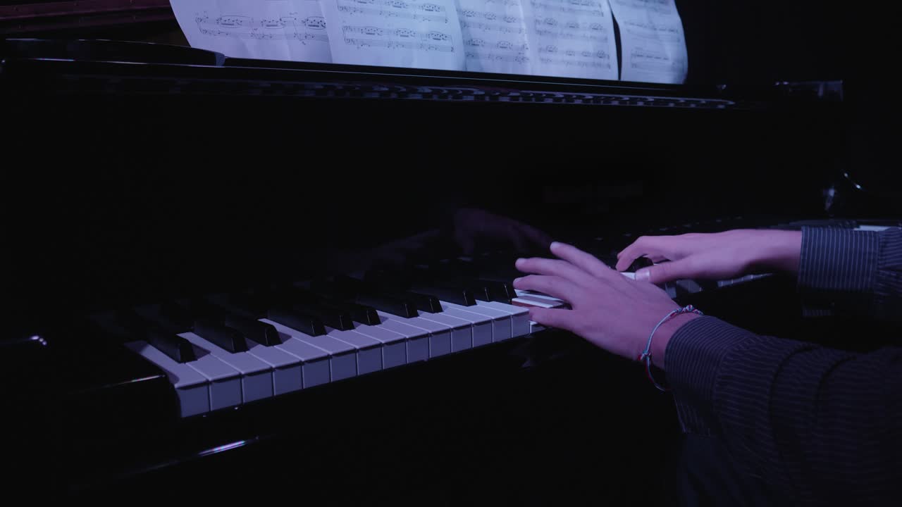 Close-up of Hands Playing Grand Piano with Sheet Music