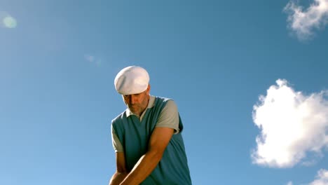 handsome golfer swinging his club