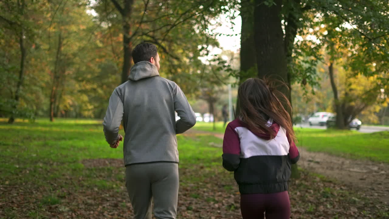 Couple jogging in the park in autumn