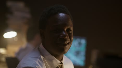 portrait of a smiling business man in a dark office