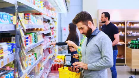 a busy grocery aisle scene featuring shoppers examining products and making selections amidst a colorful display of groceries and household items