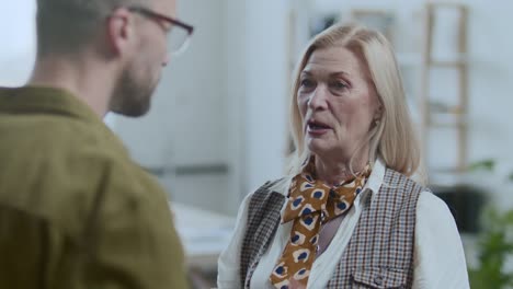 senior female ceo discussing business plans with colleague in office
