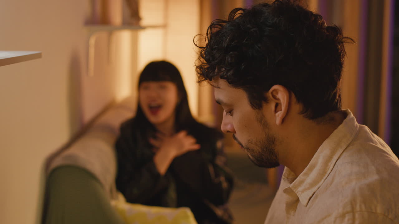 A man playing keyboard while a woman sings