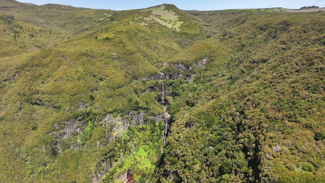 Wide drone view of Levadas Cascata do Risco in lush mountainous terrain, Madeira