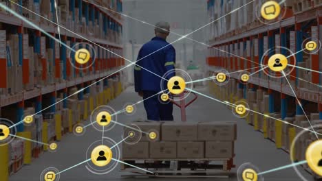 Network-of-profile-icons-against-rear-view-of-male-senior-worker-pulling-a-pallet-at-warehouse