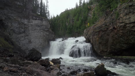 cinematic pan down slow motion firehole river waterfall canyon drive west yellowstone national park grand loop stunning fall autumn midday october tourist view wyoming idaho montana fish jumping