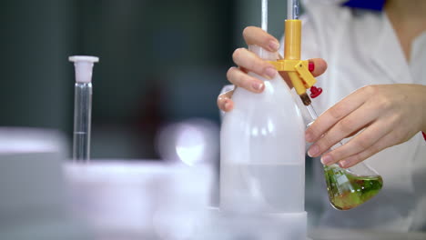 chemical reaction in flask at chemistry lab. closeup of chemical experiment