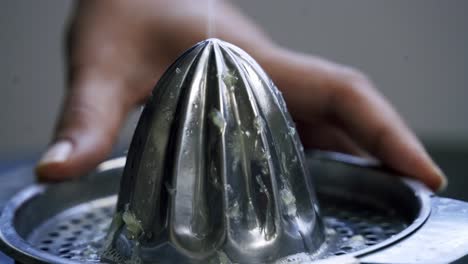 Close-up-of-lime-juice-being-dripped-onto-juicer-vitamin-c-citrus-lime-lemon-acidic