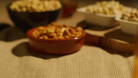 close up of bowls of cashews dry roasted peanuts and pistachio nuts in studio 1