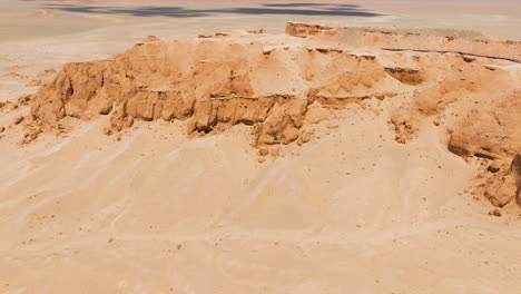 Rock-Formations-Of-Bayanzag-Flaming-Cliffs-In-Mongolia---Aerial-Drone-Shot