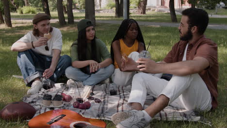 friends enjoying a summer picnic in the park