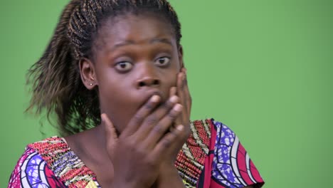 Young African woman looking shocked