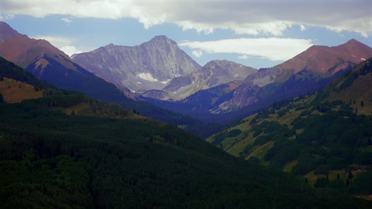 Puncak Capitol, jalur setapak di hutan belantara 14er aerial drone Colorado, sore berawan, langit biru, jalur pendakian musim panas, pemandangan lanskap indah Pegunungan Rocky, Jajaran Elk, Lembah Pohon Aspen, gerakan ke kiri