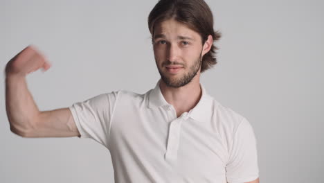 caucasian man in front of camera on gray background.