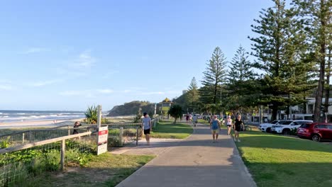 people enjoying a sunny day on a seaside path